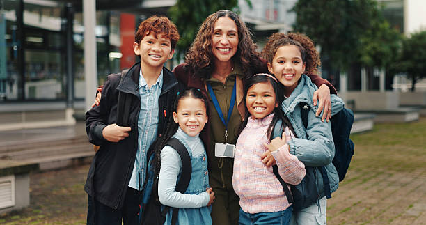 Children hug with teacher